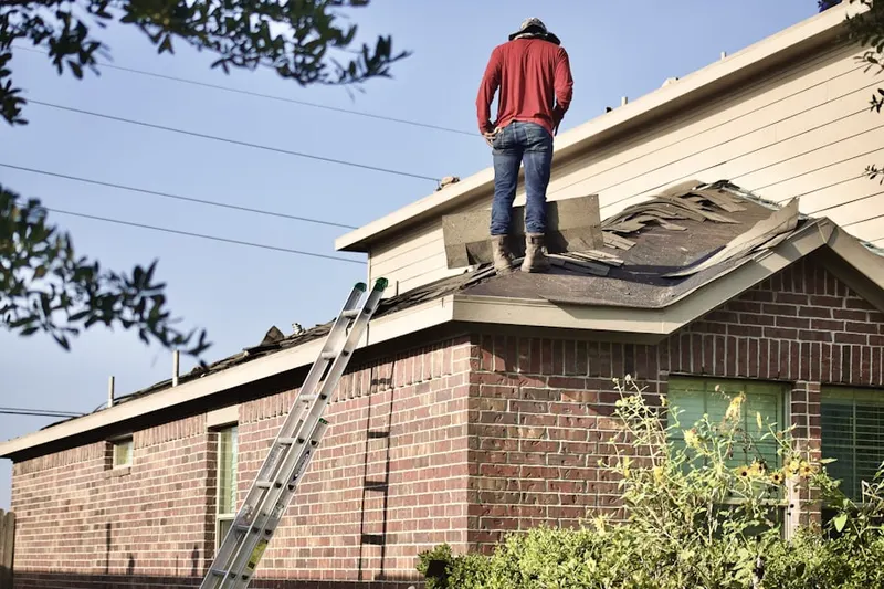 Professional roofer working on a residential roof in Cranford